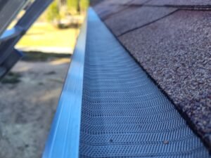 Stainless steel micro mesh gutter guards installed on a shinlged roof