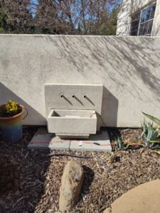 dirty stone fountain after pressure washing