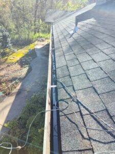 After picture of gutters overflowing with debris